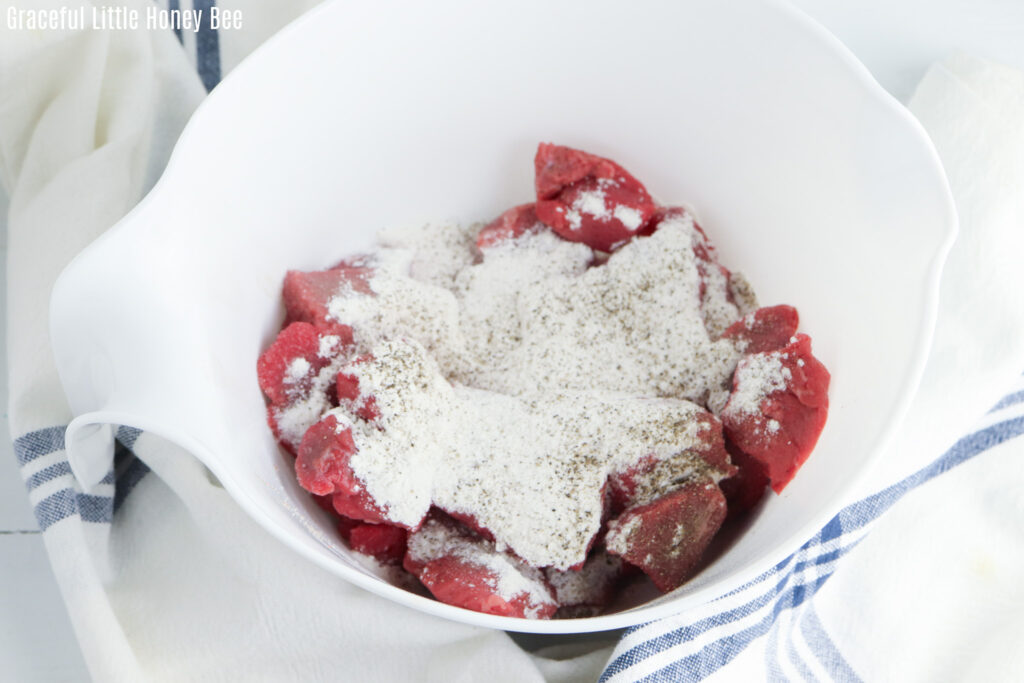 Raw stew meat, topped with flour.