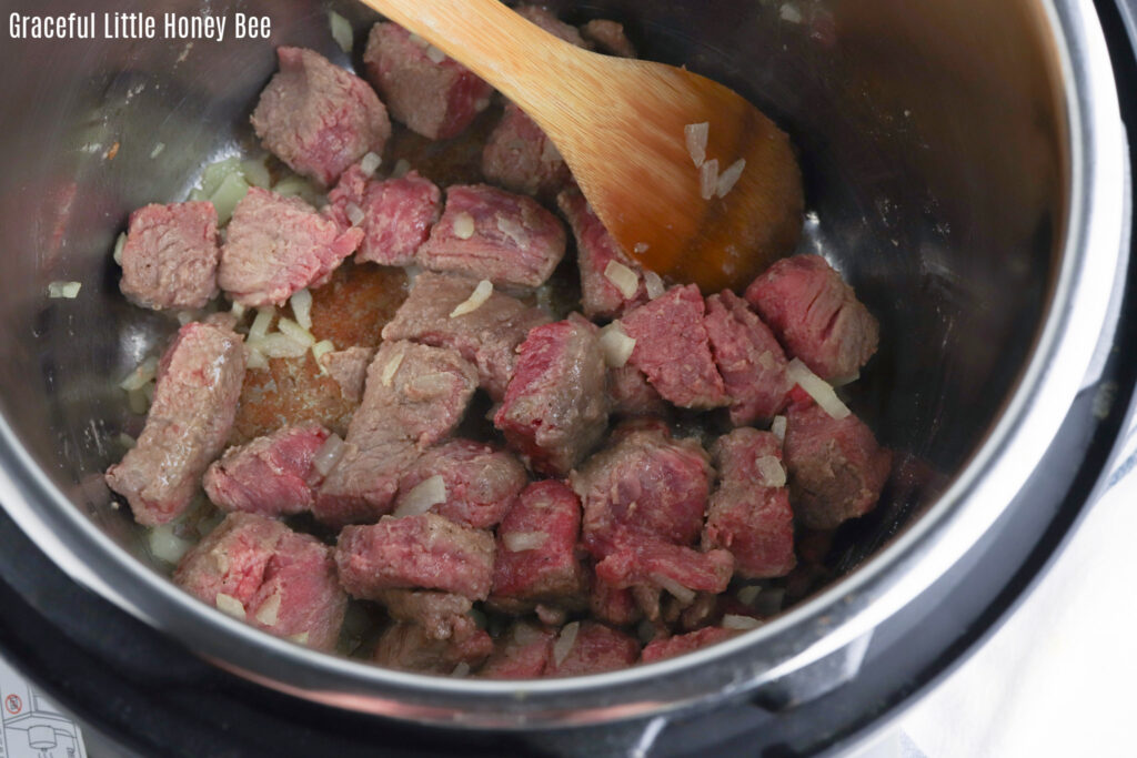 Flour coated stew meat, browning in the Instant Pot.